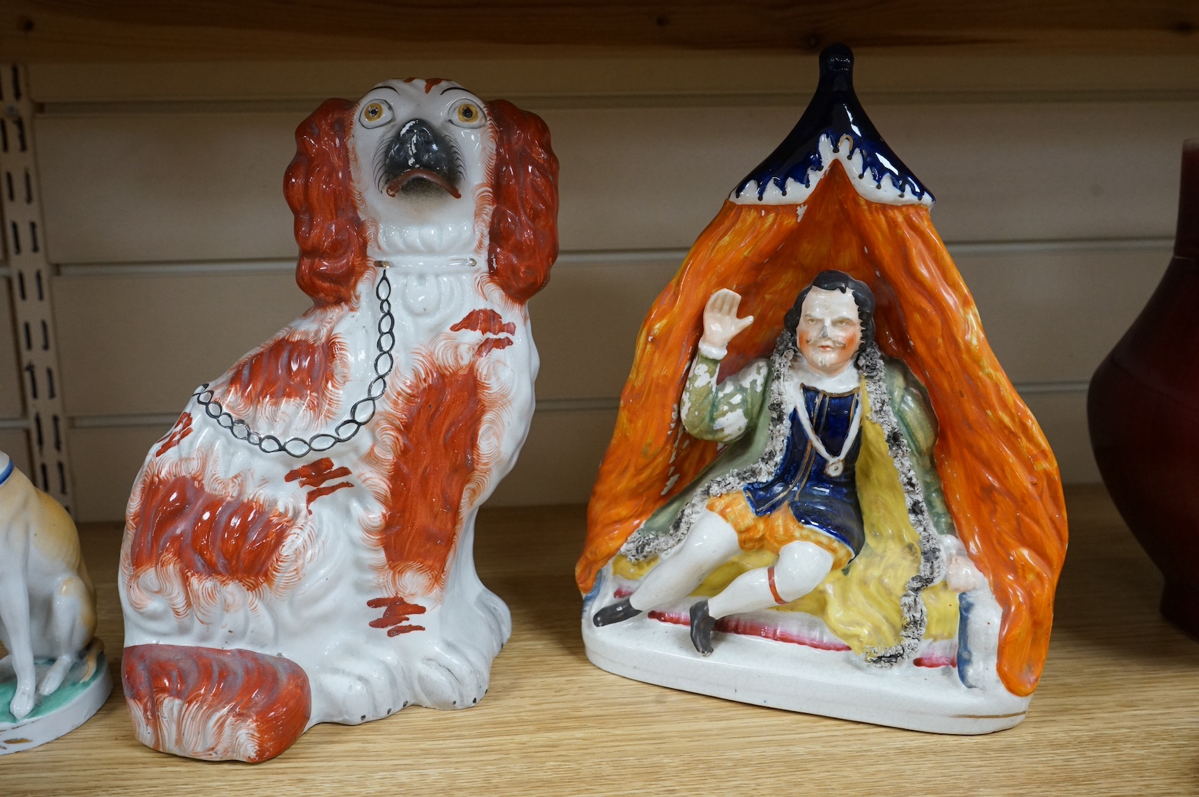 Four Victorian Staffordshire models, to include a pair of dogs, and a Nymphenburg whippet, largest 25cm high. Condition - fair/good